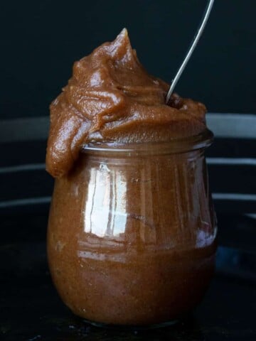 Spoon in glass jar overfilled with date past