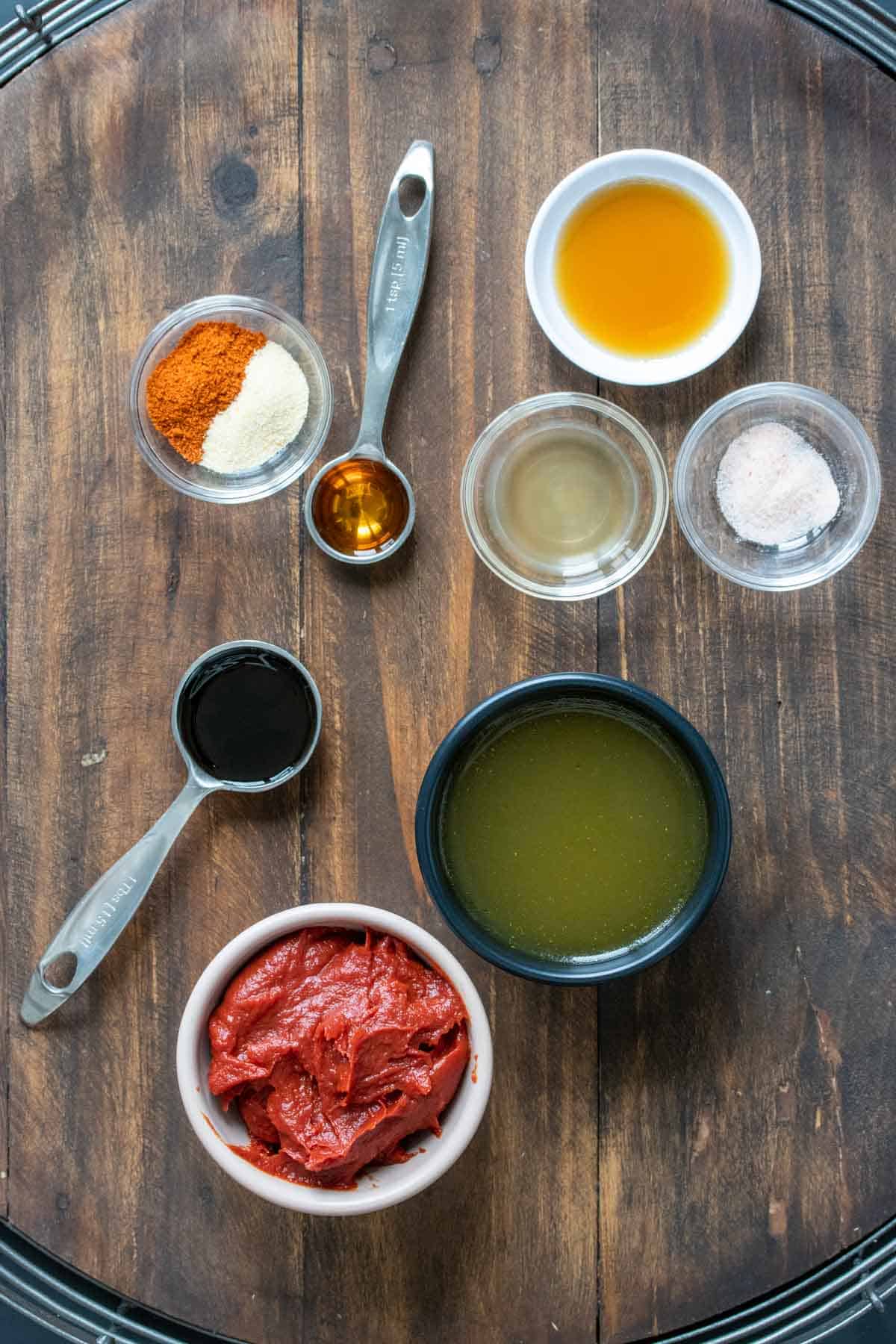 Different color and sized bowls with ingredients to make homemade bbq sauce