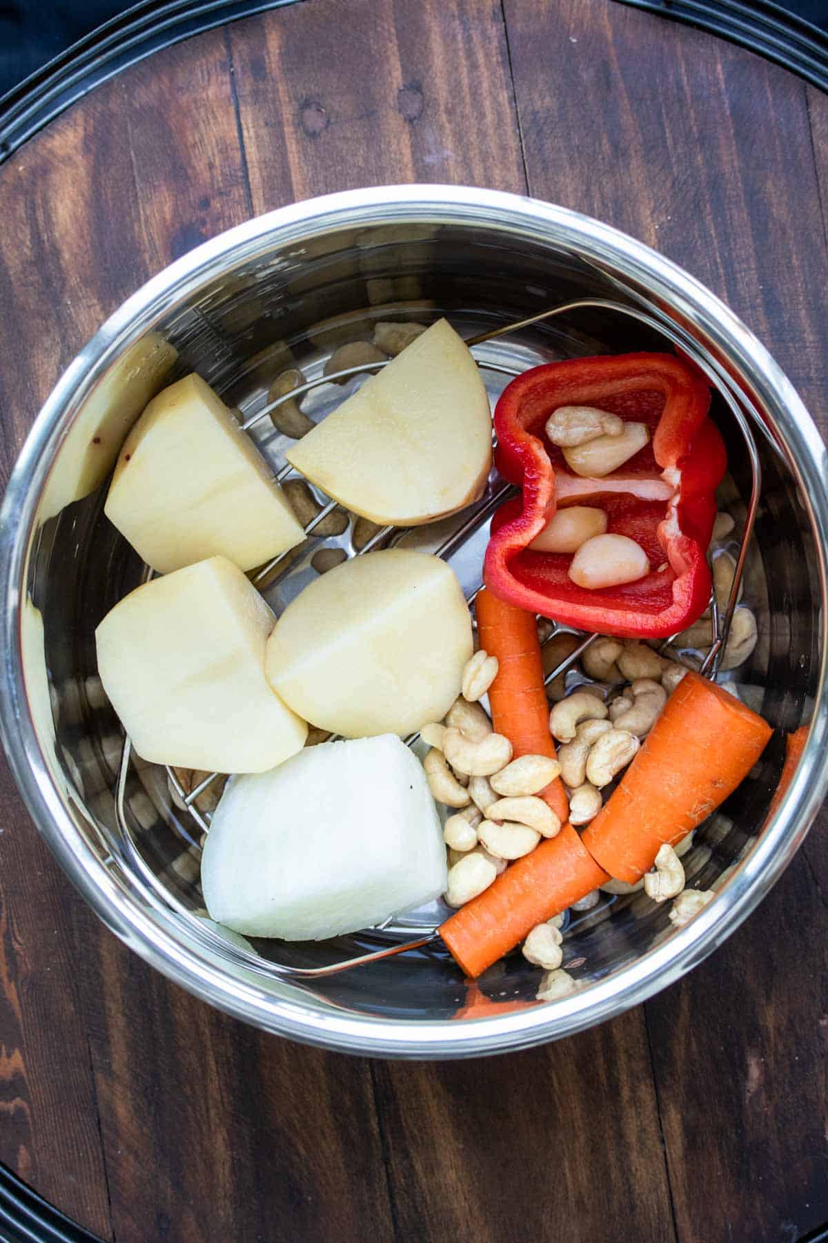 Top of silver bowl with different veggies inside.