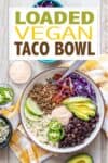 A fully loaded taco bowl in a cream colored bowl with overlay text on a vegan taco bowl