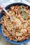 Fork twirling in spaghetti mixed with vegetable bolognese