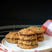 Cream plate with piles of baked cookies with chocolate chips on top