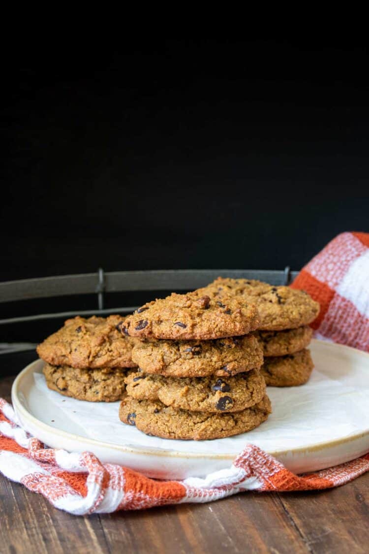 Cream plate with piles of baked cookies with chocolate chips on top