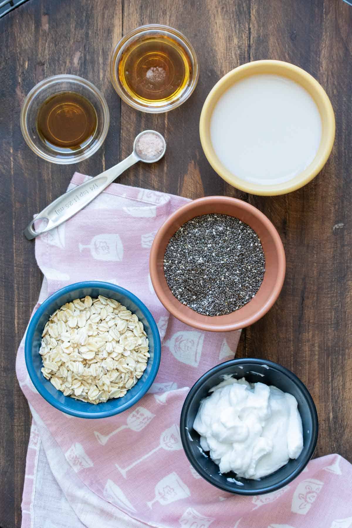 Different colored bowls with ingredients needed to make overnight oats