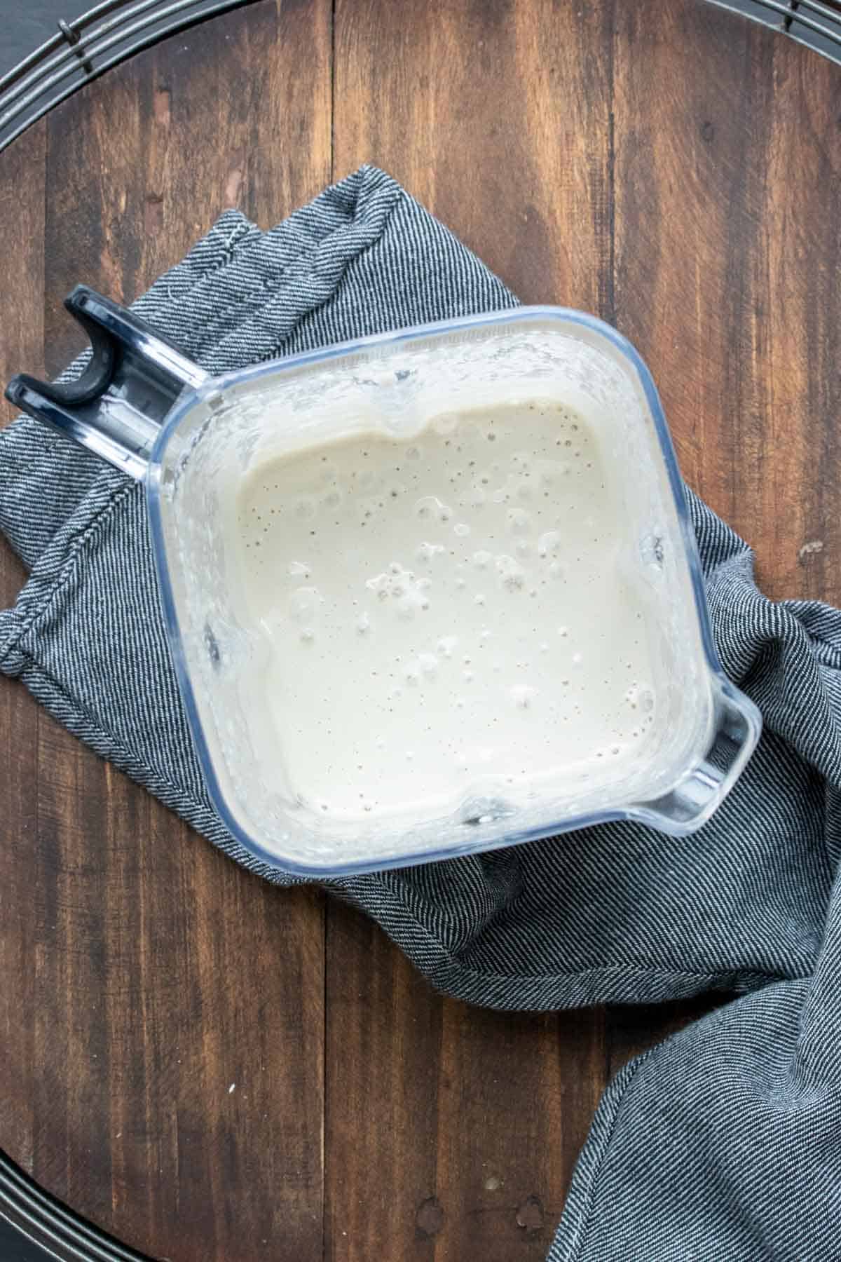 Top view of a blender with a creamy white pudding inside