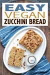 Overlay text of vegan zucchini bread with a photo of slices of the bread on a white plate with milk