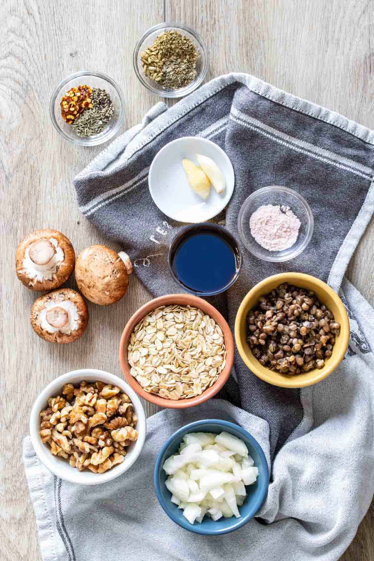 Bowls with ingredients needed to make homemade vegan sausages with a lentil and veggie base.