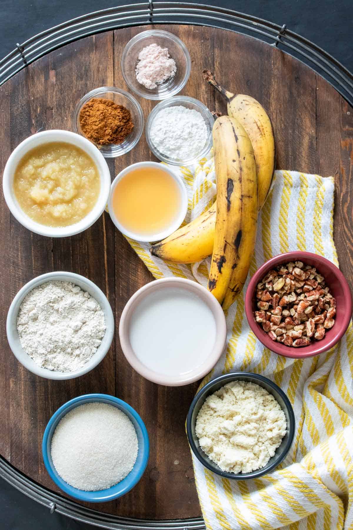 Ingredients needed to make banana bread on a wooden tray
