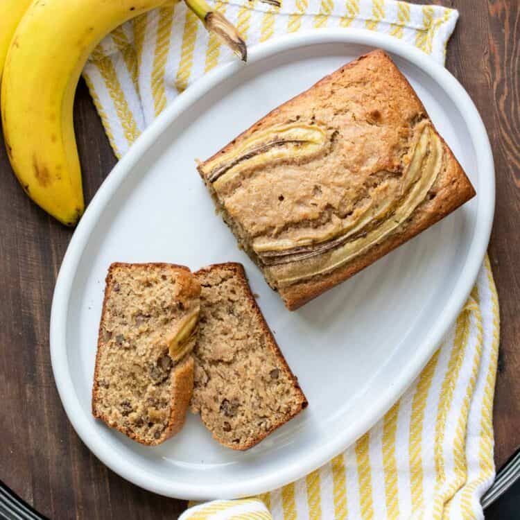 Top view of a banana bread loaf and two slices