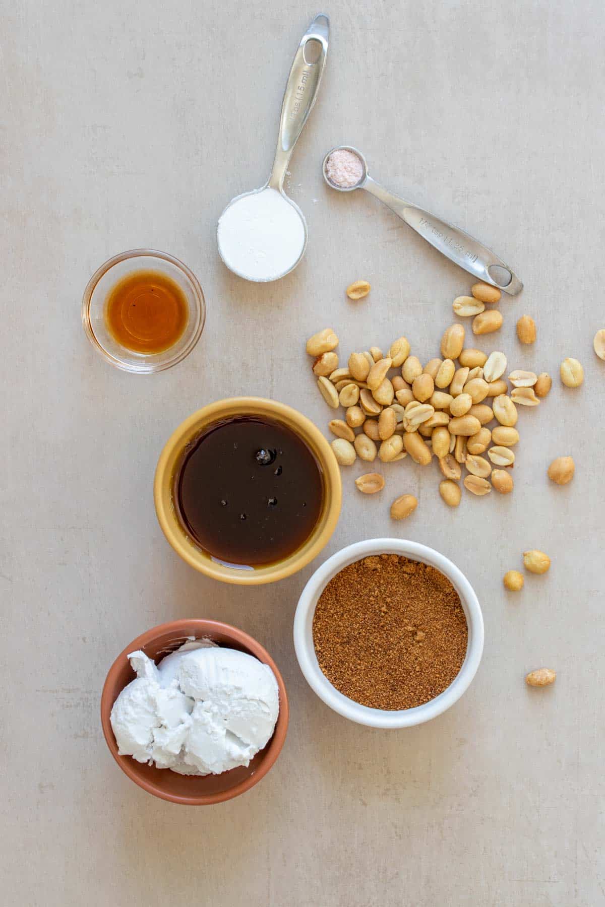 Ingredients needed to make a peanut brittle sitting on a tan surface