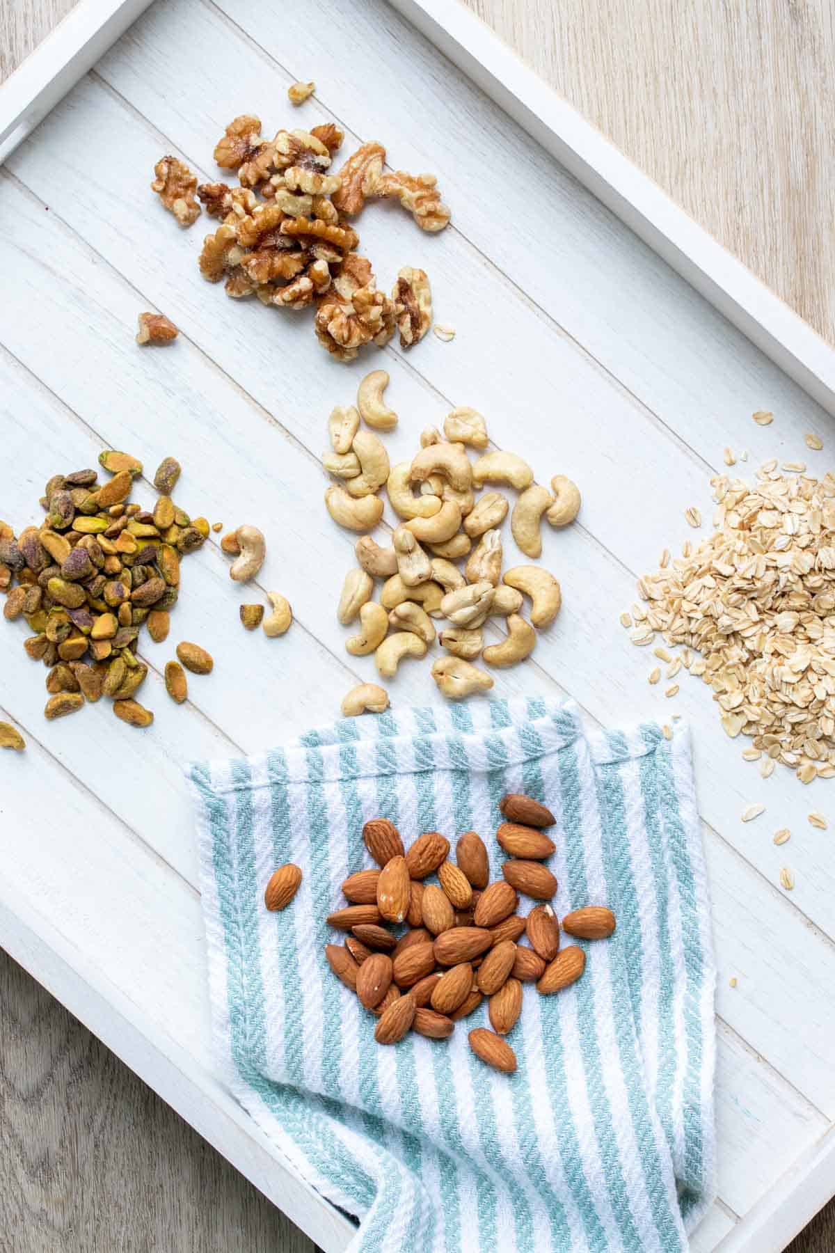 Top view of a white tray with piles of nuts on it