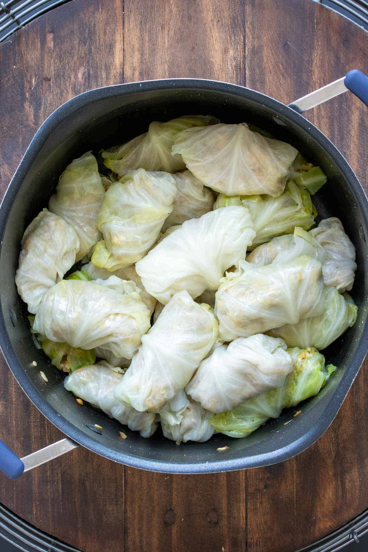Rolls of stuffed cabbage piled into a black pot