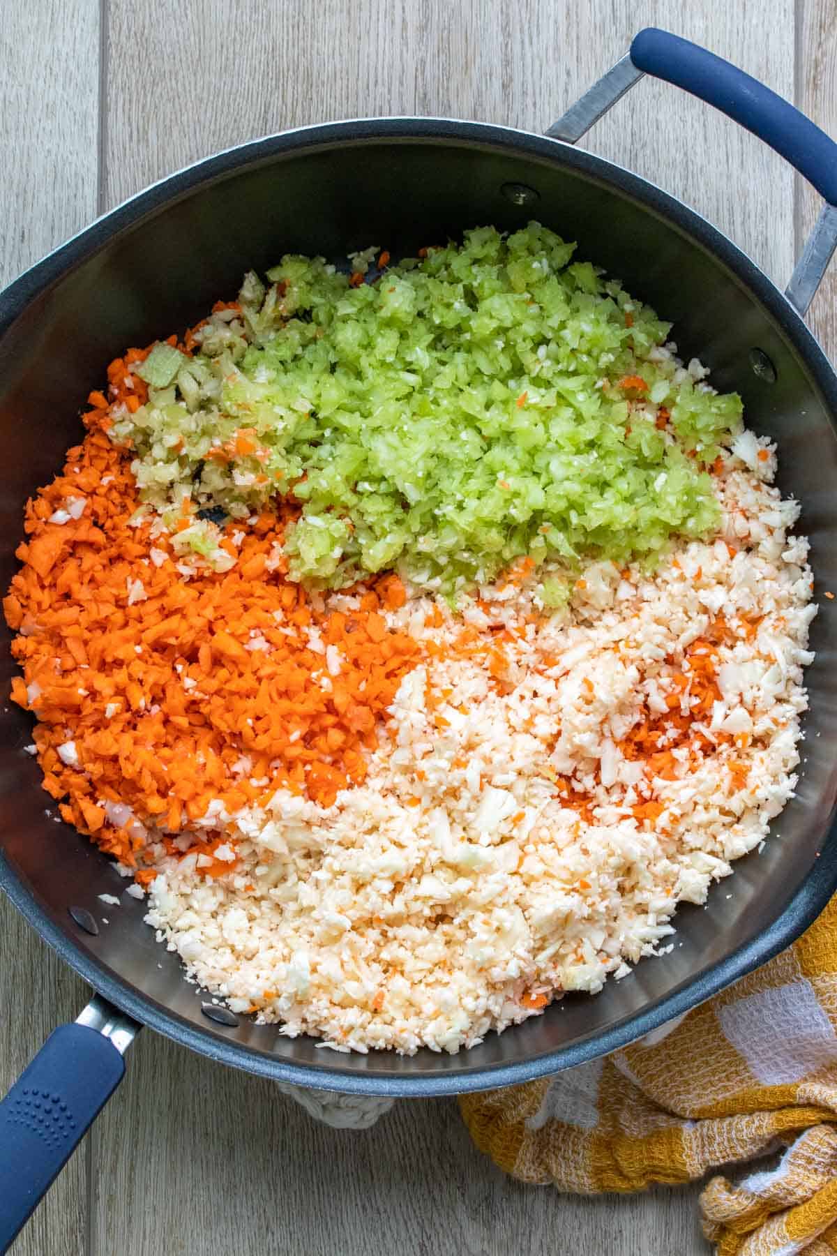 Finely chopped carrots, celery and cauliflower in a pan