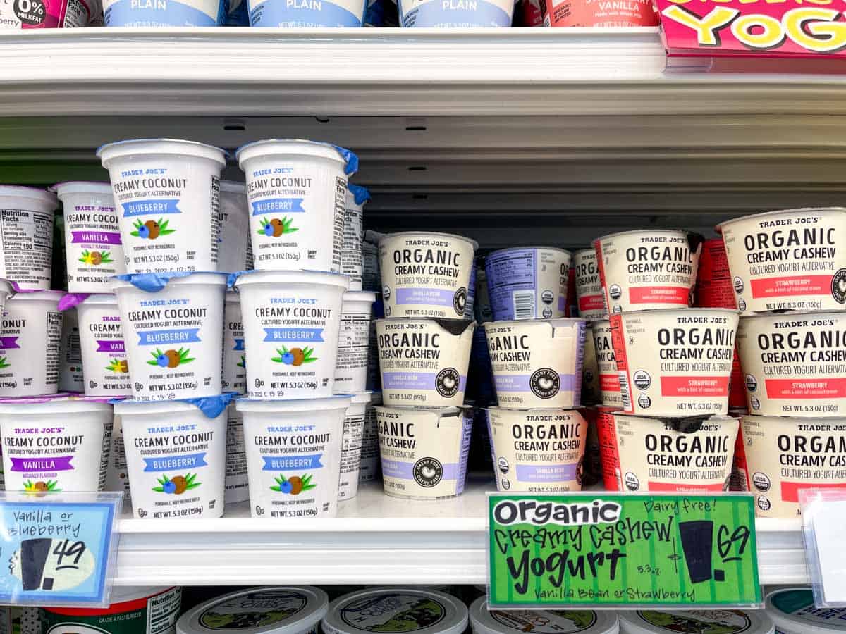 Dairy free yogurt varieties on a shelf in a grocery store