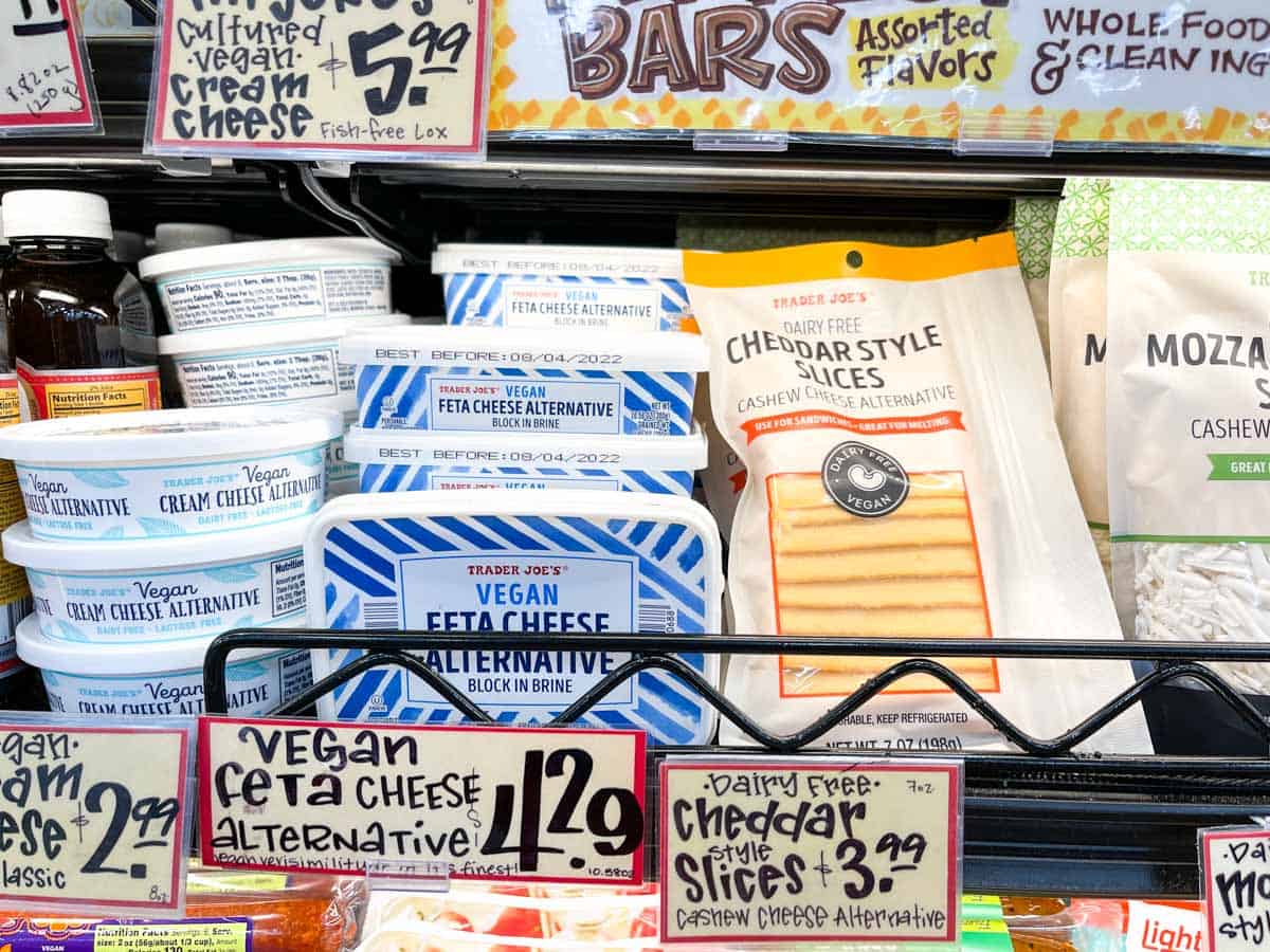 Different dairy free cheeses on a shelf in a grocery store