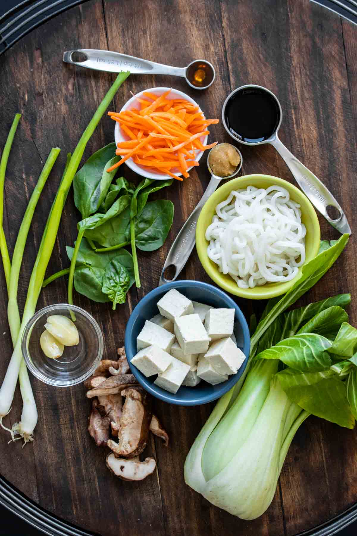 Top view of veggies, noodles, tofu and asian style ingredients for a miso soup.