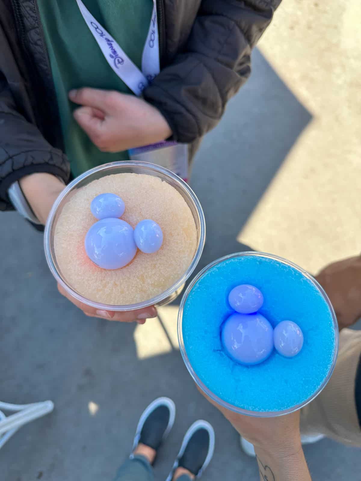 Top view of two plastic cups with mickey lights in them and frosties.