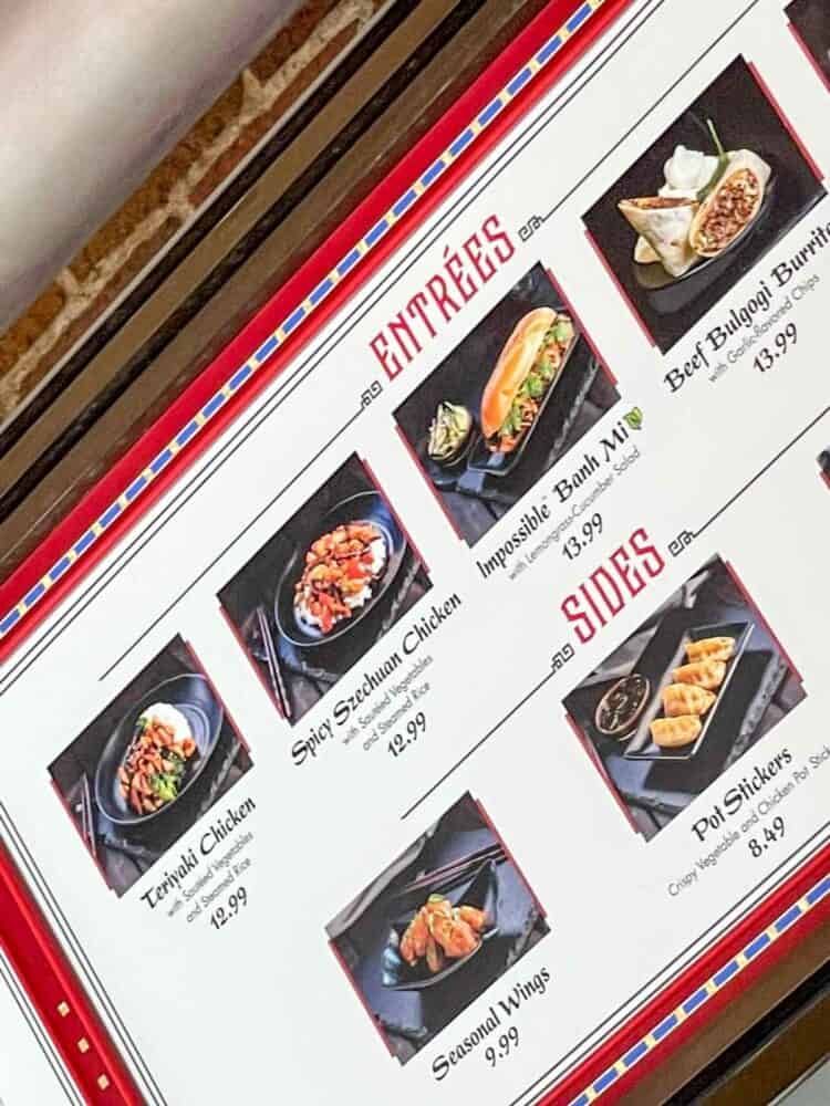 A sign from a food stand showing different Asian style entrees and sides.