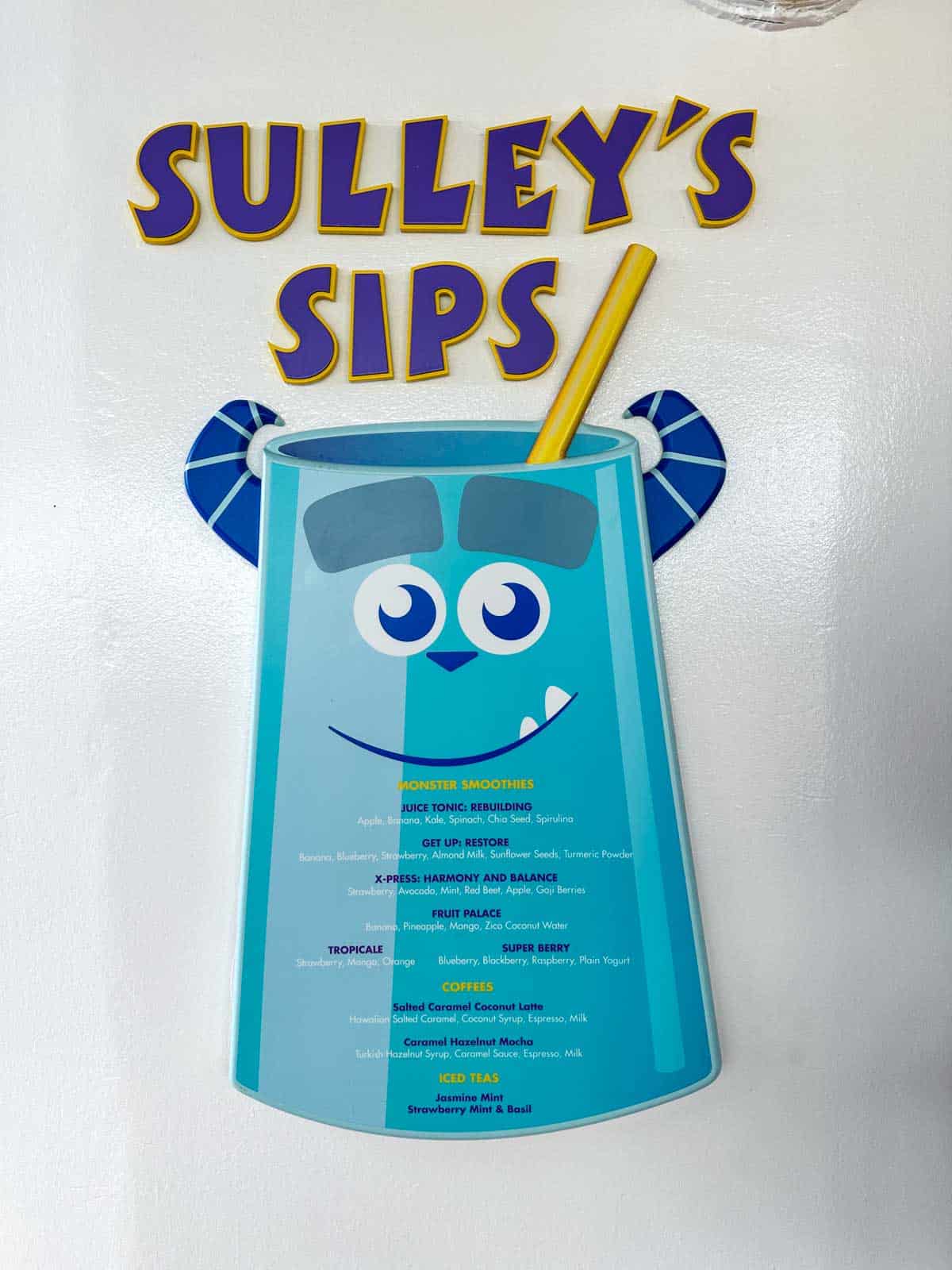 A blue sign of Sulley from Monsters inc with menu items for smoothies.