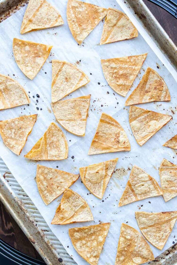 Bakes corn tortilla chips on a parchment lined cookie sheet.